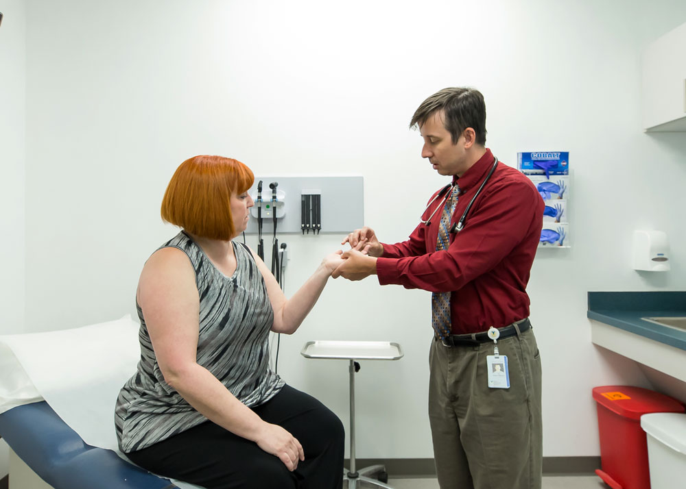 Rheumatology doctor examining patient's hand